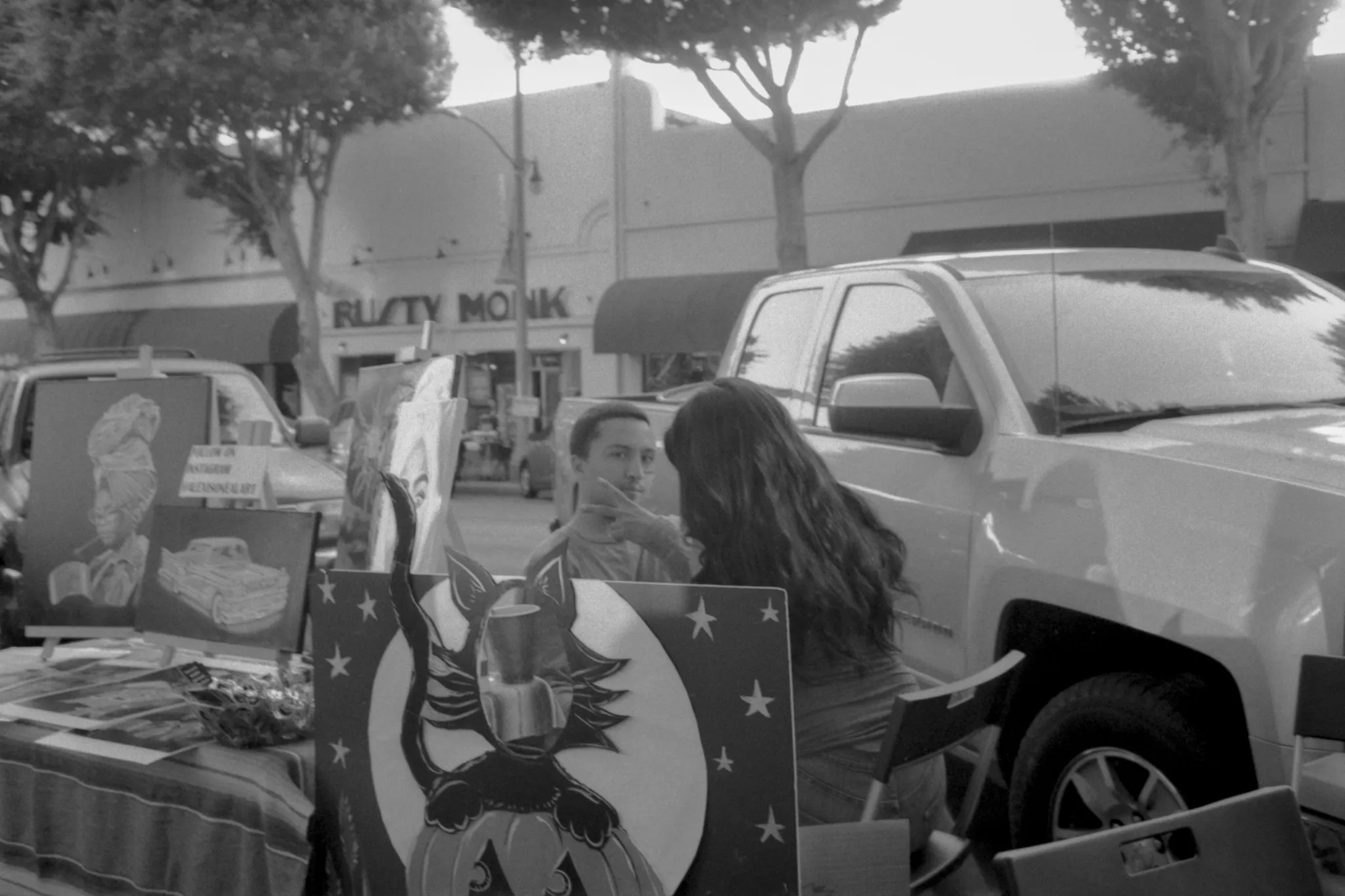 Black and White photo of man getting face paint