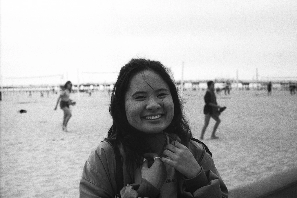 Woman smiling in front of a beach