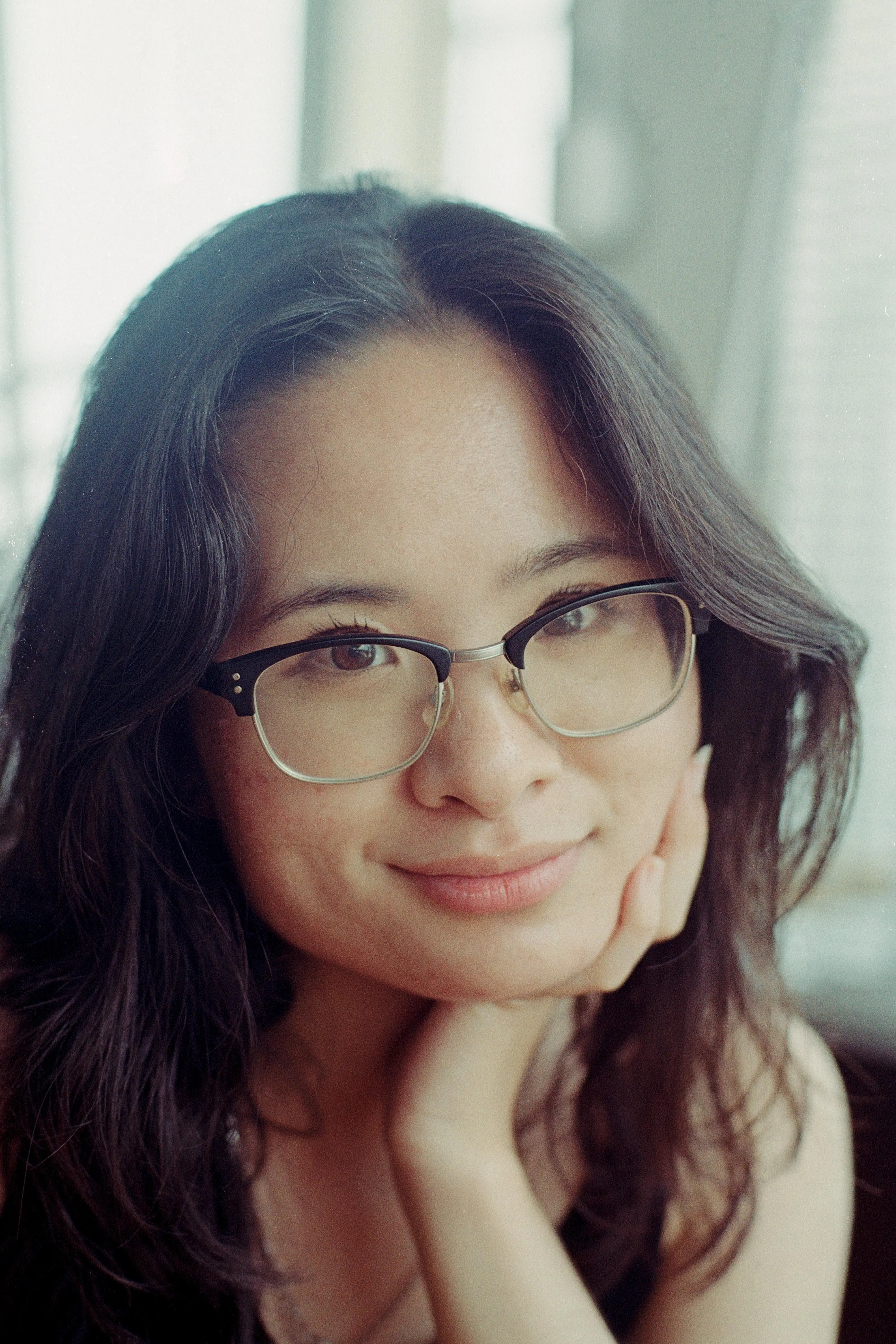 Woman resting her head on her hand and smiling