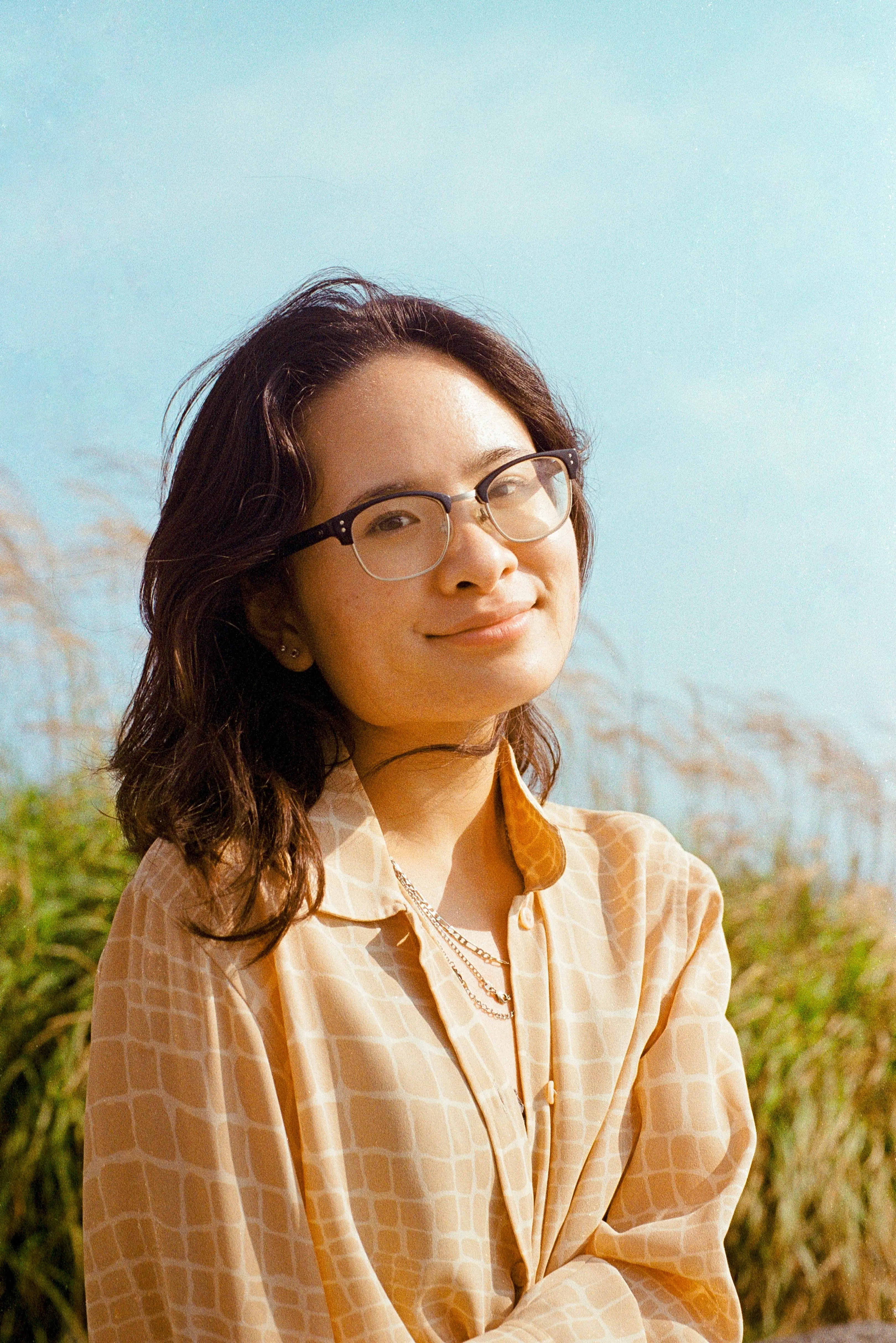 Woman smiling in front of a beach